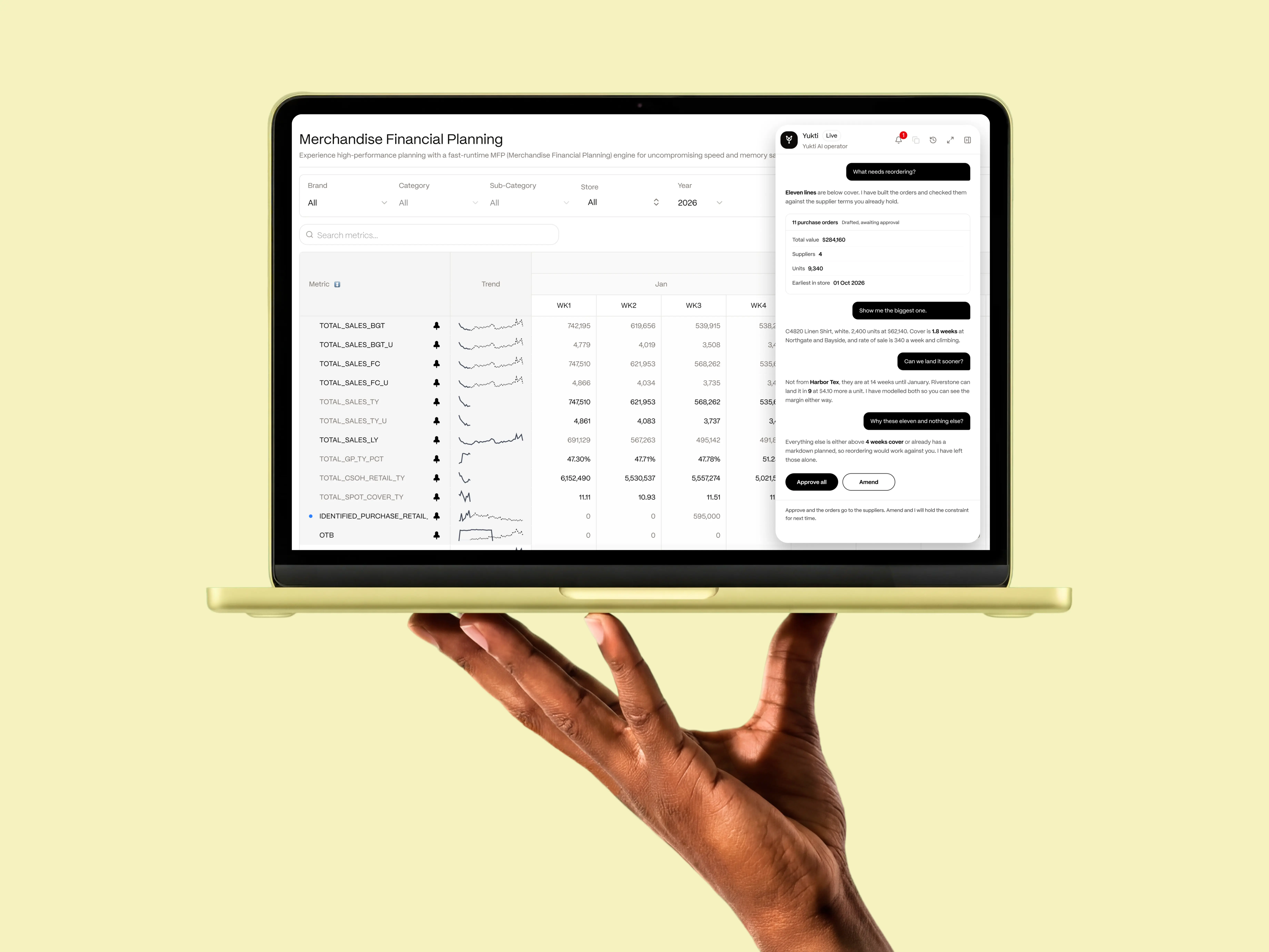 A hand holding a laptop showing Merchmix merchandise financial planning and the yukti assistant